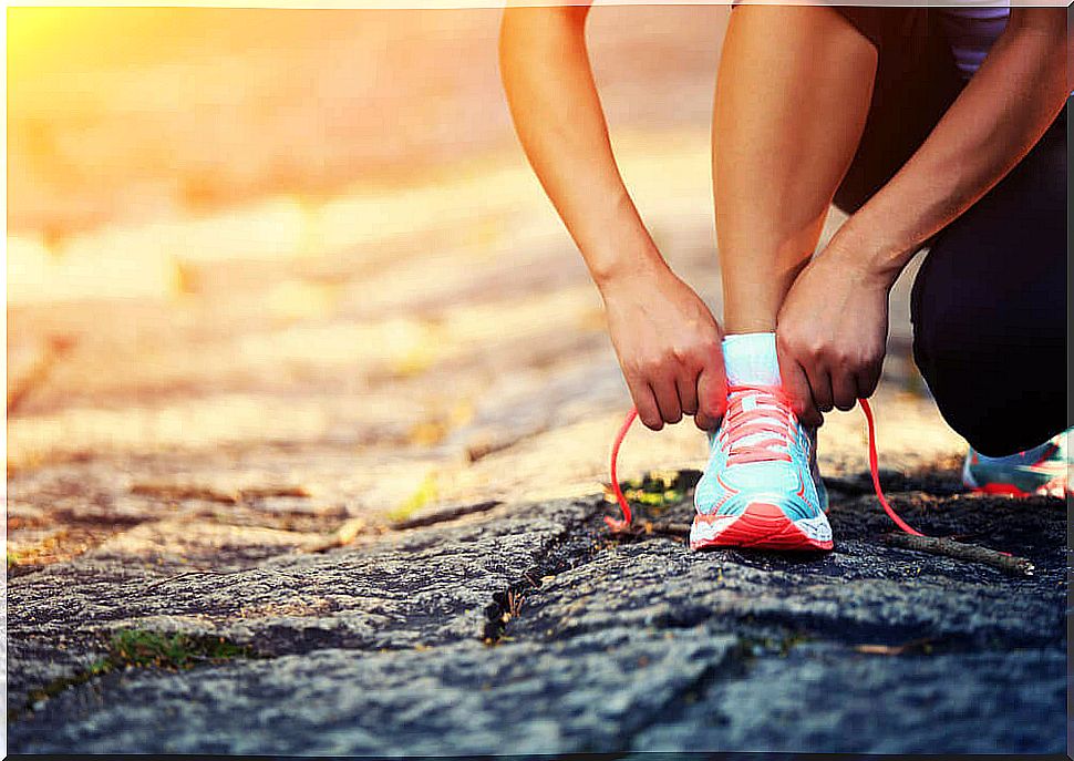 woman tying running shoes