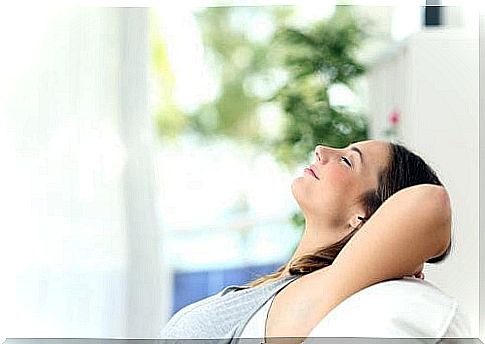 Woman resting after cleaning the house.