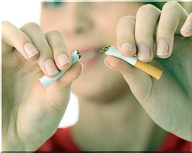 Woman breaking cigarette in half because it is necessary to take care of the pancreas