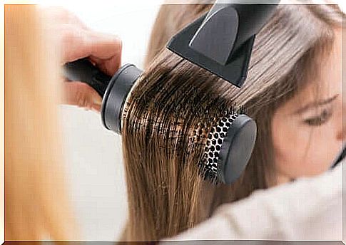 woman using hair dryer