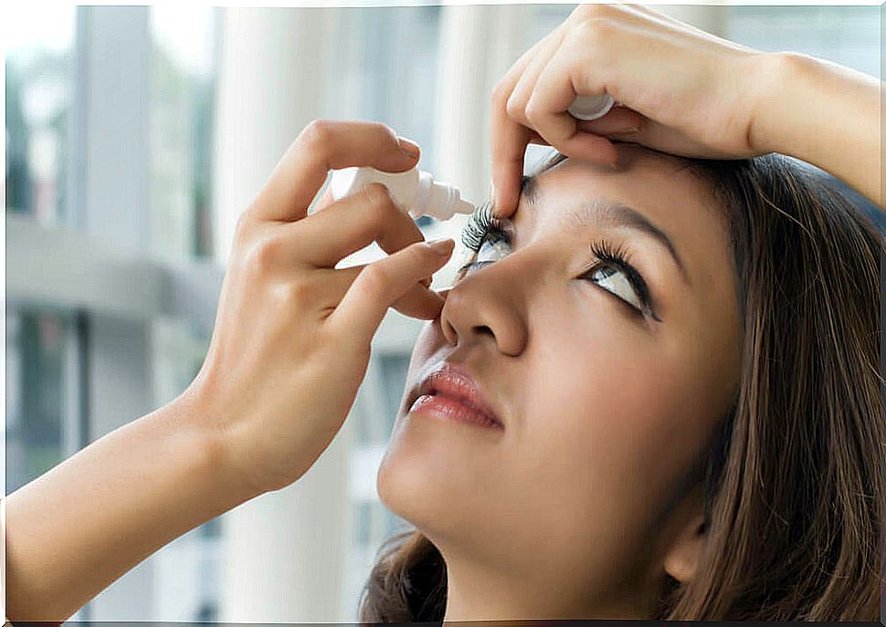 woman using eye drops