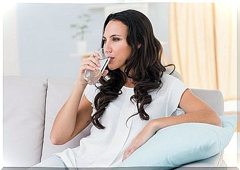 Woman drinking water before meal